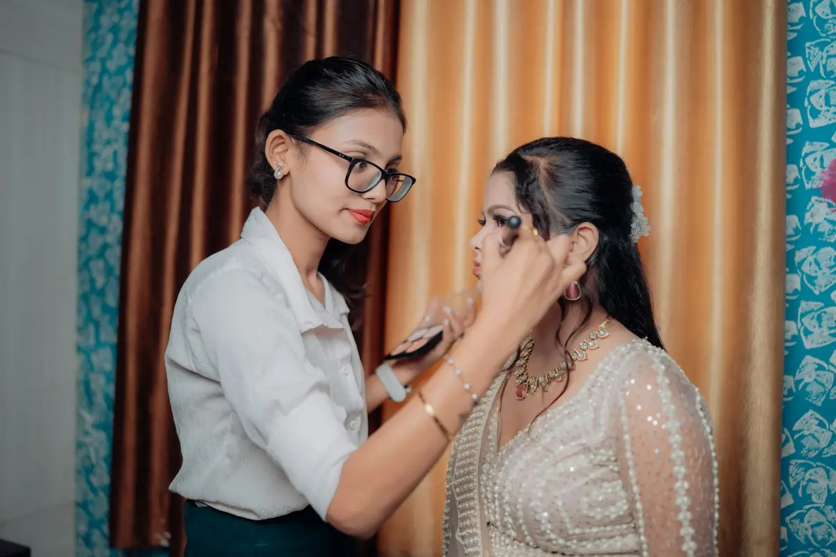 A makeup artist doing a client's eye makeup in a salon